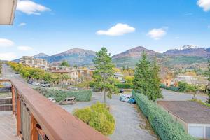 a balcony with a view of a city and mountains at Appartement T3 in Embrun