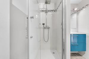 a shower with a glass door in a bathroom at Appartement T3 in Embrun +34 photos