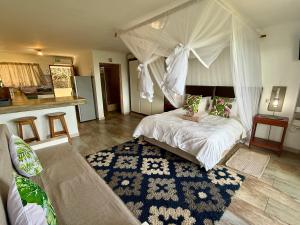 a bedroom with a bed with a canopy at Go Wild Beach Resort in Quebanhane