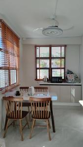 南迪Helen House一间带独立卫生间的温馨卧室的房间里有一张桌子和几把椅子的厨房