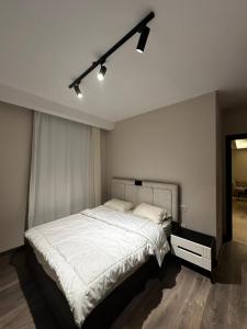 - une chambre avec un grand lit blanc dans l'établissement شقة فندقيه ابراج zedالشيخ زايد, à Sheikh Zayed