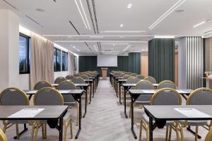 a row of tables and chairs in a room at Hilton Garden Inn Athens Syggrou Avenue in Athens +68 photos