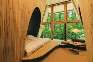 a room with a bed and a large window at SANU 2nd Home 八ヶ岳2nd in Hokuto