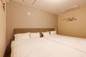 Ένα ή περισσότερα κρεβάτια σε δωμάτιο στο Nihonbashi Glowview