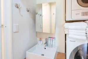 een kleine keuken met een spoelbak en een magnetron bij Nihonbashi Glowview in Wada