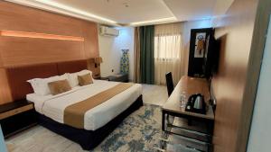 a hotel room with a bed and a television at ميرا سويت للشقق المخدومة in Jeddah