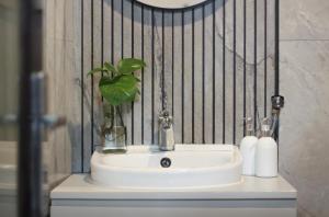 a bathroom sink with a plant in a vase on it at 2 Bedrooms Private Pool Villa Lovina in Buleleng +5 photos