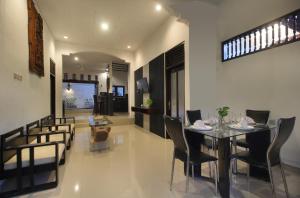 a dining room and living room with a table and chairs at 2 Bedrooms Private Pool Villa Lovina in Buleleng