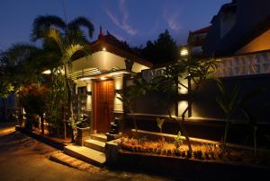 a house with lights on the side of it at night at 2 Bedrooms Private Pool Villa Lovina in Buleleng
