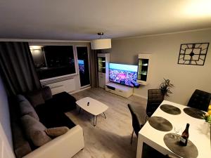 a living room with a couch and a table at Gdańsk - Quiet area with a sea view in Gdańsk