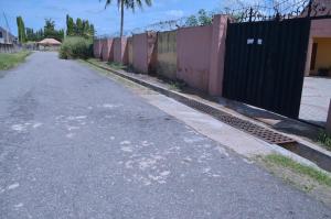 an empty street next to a fence and a road at Metroluxe in Akure +4 photos