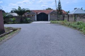 an empty driveway in a house with a garage at Metroluxe in Akure