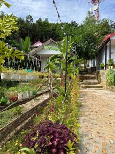 a garden in front of a house with flowers at SODANY RESORT Kohrong in Koh Rong