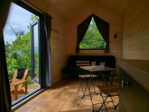 a small room with a table and a window at Off-Grid Nature Tiny House Retreat & Simple Living in San Martino