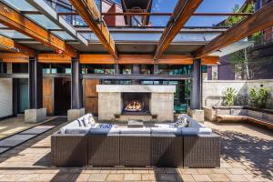 an outdoor patio with a fireplace and a couch at Main & SKY Park City Utah in Park City