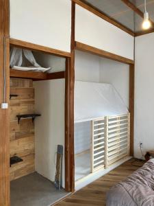 a bedroom with two bunk beds in it at お宿イヌとネコと in Shima