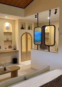 a room with two mirrors on the wall at Andara Villa Yogyakarta in Yogyakarta