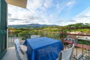 a table and chairs on a balcony with a view at Silvia sul Lungomare di Campo in Marina di Campo