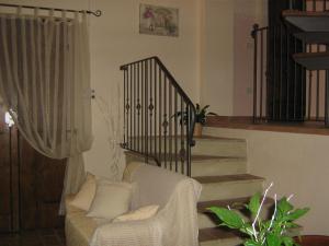a living room with a couch and a staircase at Ferienwohnung Rose In Cagli in Cagli