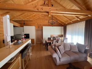 a kitchen and living room with a couch and a table at Alpenzeit Lachtal in Lachtal