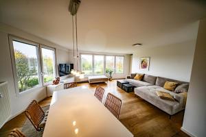 a living room with a couch and a table at Ferienwohnung Auerose in Wesel