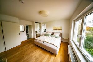 a bedroom with a bed and a large window at Ferienwohnung Auerose in Wesel