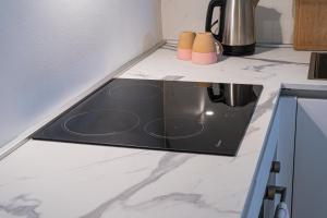 a kitchen counter with a stove top in a kitchen at Zambianchi Studio - Sostify in Bergamo
