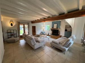 a large living room with two couches and a table at Les Grandes Vagastines in Saint-Germain-du-Plain