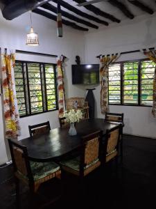 a dining room with a black table and chairs at Mimi ni wako in Watamu