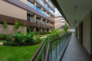 a balcony of an apartment building with a garden at Holiday Inn Pu'er Jingmai by IHG in Mengman