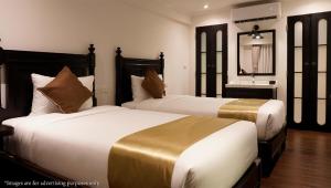 Postel nebo postele na pokoji v ubytování Bangluang Boutique Hotel