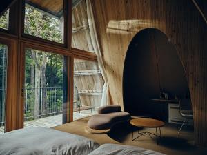 a bedroom with a bed and a large window at SANU 2nd Home 那須2nd in Nasu