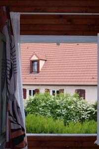 a window with a view of a red roof at Studio 2 A3M Locations in Limay