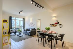 a living room with a table and a couch at EE's Summer House - Homestay 3 min walk to beach in Batu Ferringhi