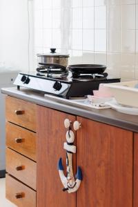 a kitchen counter with a stove top in a kitchen at EE's Summer House - Homestay 3 min walk to beach in Batu Ferringhi