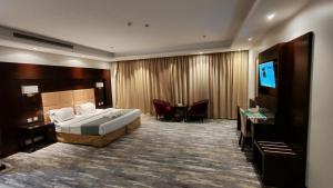 een hotelkamer met een bed en een flatscreen-tv bij ارجان المتميزة للشقق المخدومة in Jeddah