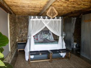 a bedroom with a bed with a canopy at Elandskop in Breede River DC