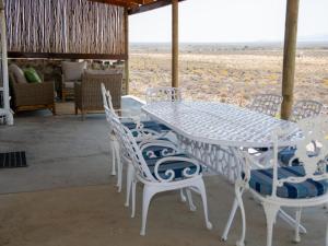 a white table and chairs with a view of the desert at Elandskop in Breede River DC