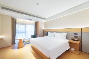 Ένα ή περισσότερα κρεβάτια σε δωμάτιο στο JI Hotel Beijing Yizhuang Rongchang West Street +36 φωτογραφίες