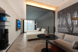 a living room with a couch and a table at Atour S Hotel Beijing International Trade CBD Jianguo Men in Beijing