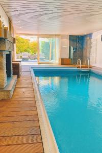 a large swimming pool in a house at suite4you Erlen in Erlen