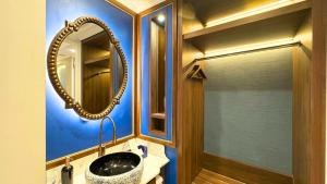 ein Badezimmer mit Spiegel und Waschbecken in der Unterkunft Ashley NewAir Menteng with Air Purifier in Jakarta