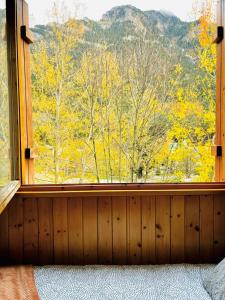 a bedroom with a window with a view of trees at Mira Moleta bienvenidos a Canfranc in Canfranc-Estación