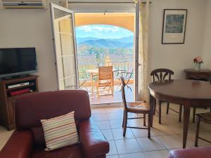 a living room with a couch and a table at Casa Helena in Saint-Florent