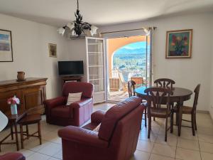 a living room with a couch and a table and chairs at Casa Helena in Saint-Florent