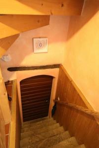 a staircase leading to a garage with a door at Casa Holamundo in Curtina +19 photos