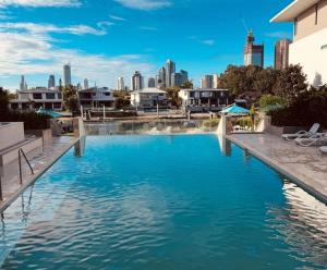 a swimming pool with a city skyline in the background at The Broadbeach Retreat in Gold Coast