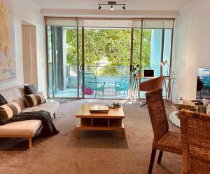 a living room with a couch and a table at The Broadbeach Retreat in Gold Coast