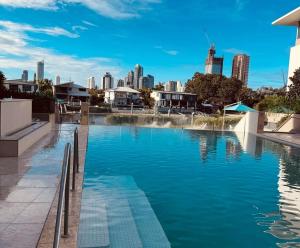 a swimming pool with a city skyline in the background at The Broadbeach Retreat in Gold Coast +5 photos