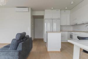 a living room with a couch and a kitchen at Porvoo Sibelius - Free WiFi in Porvoo